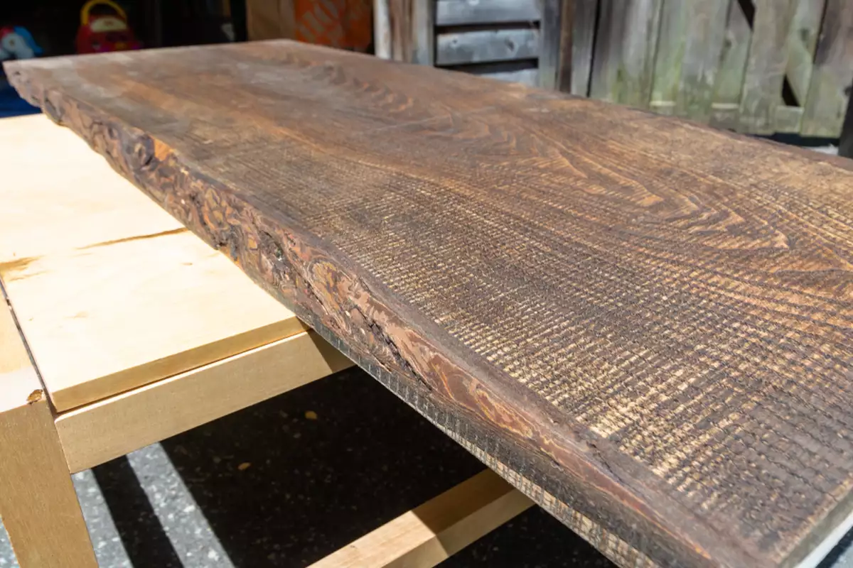 A live edge slab lying on a worktable.